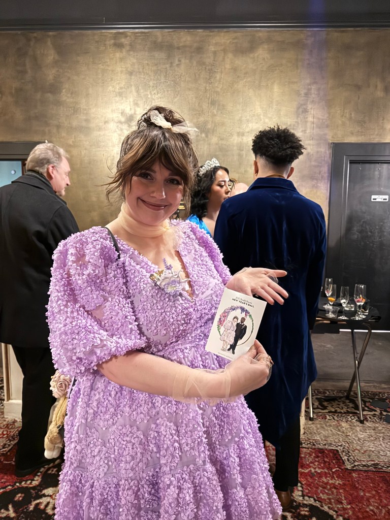 Girl in regency attire holding custom tehremy live guest sketch