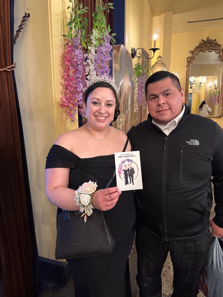 Couple in regency attire holding custom tehremy live guest sketch