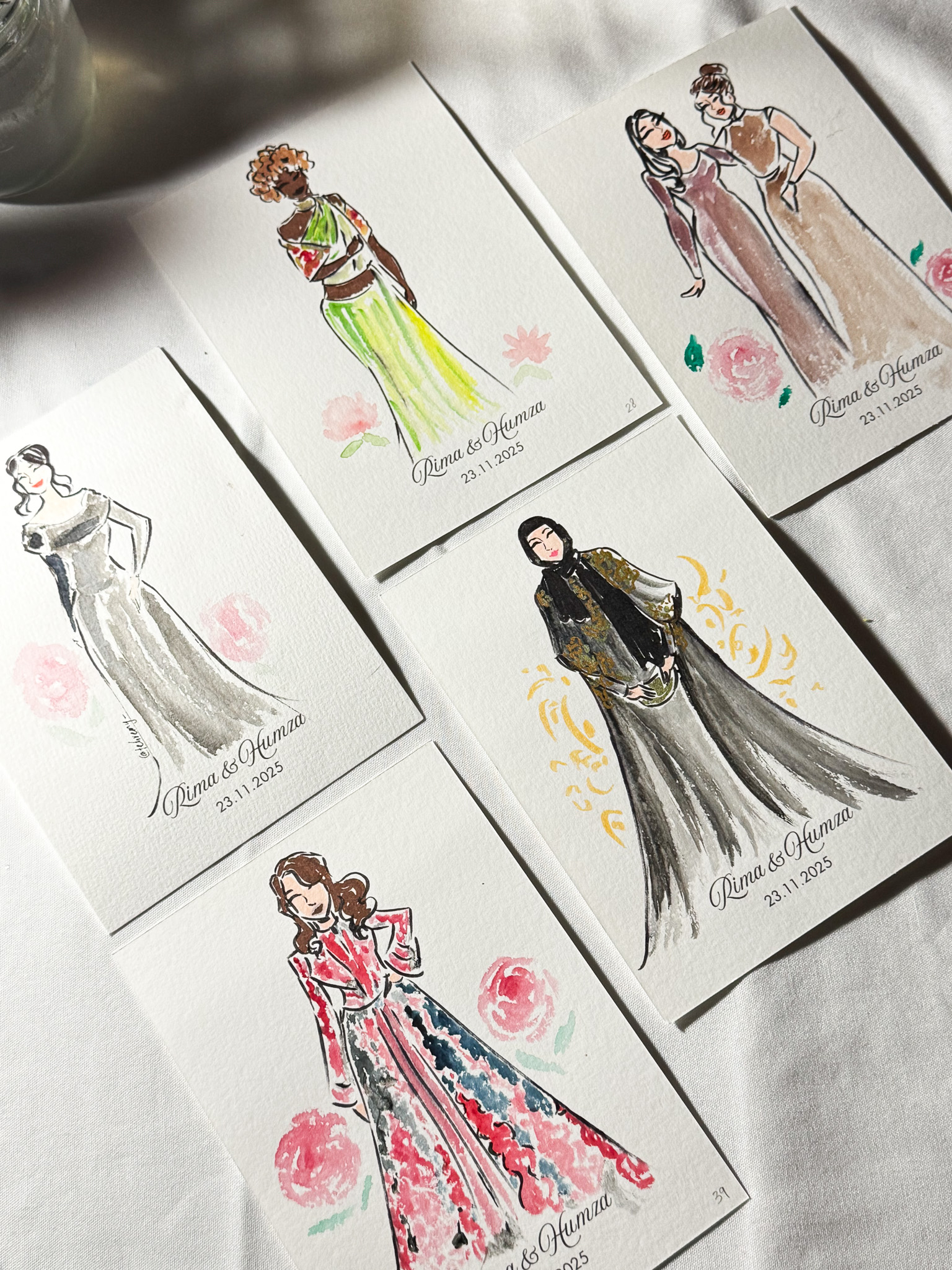 sheets of paper with watercolour paintings of people on them