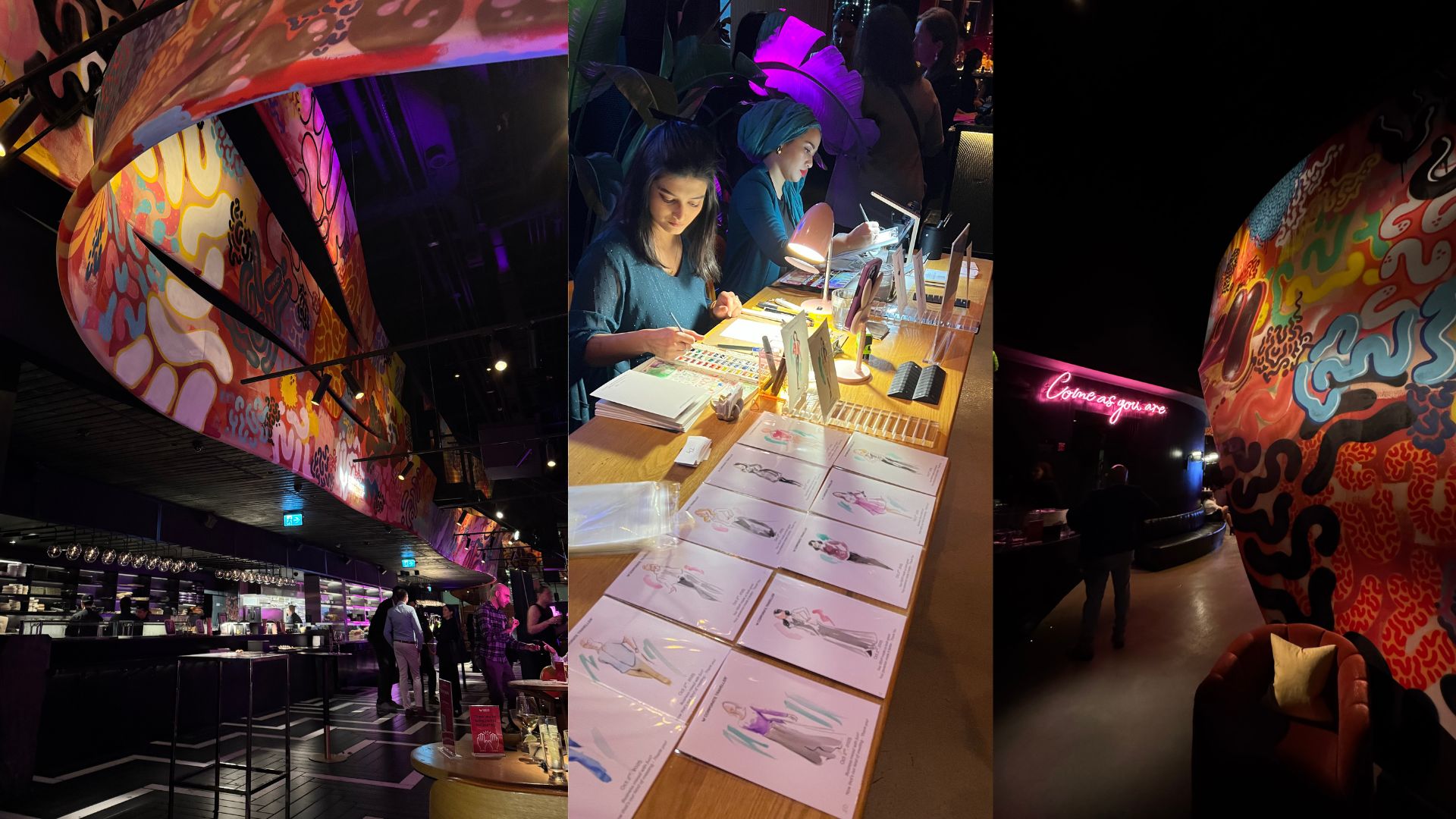 Interior view of a vibrant venue featuring colorful hanging artwork, a stylish bar, and people mingling.